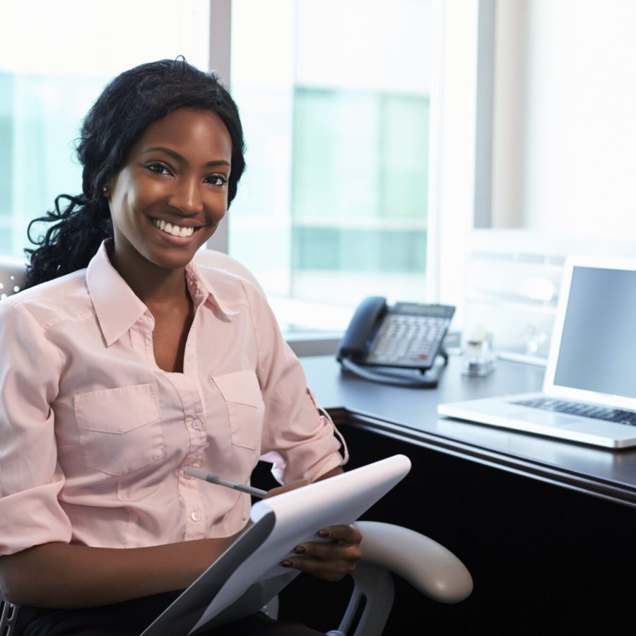 Portrait Of Female Doctor Working In Office