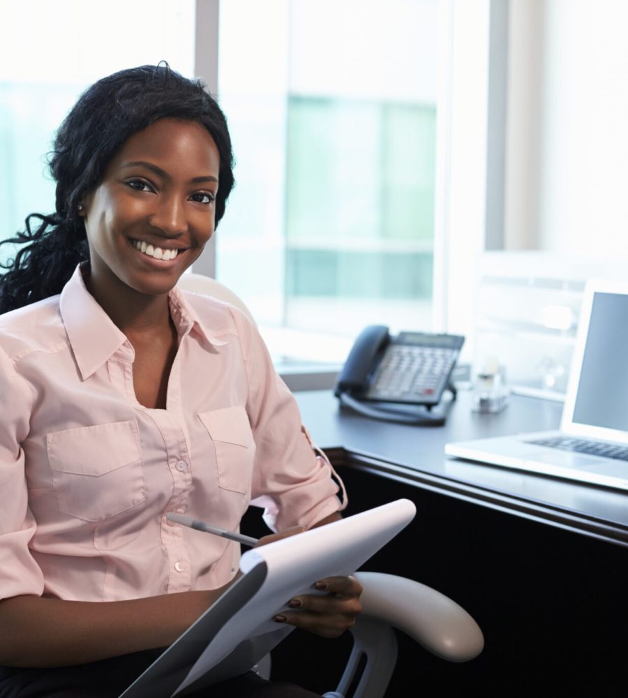 Portrait Of Female Doctor Working In Office